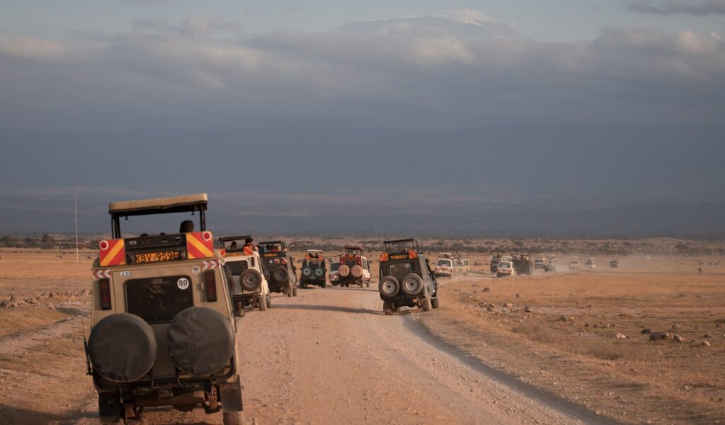Unforgettable top Tourist Attractions in Kenya 2 a group of jeeps driving down a dirt road